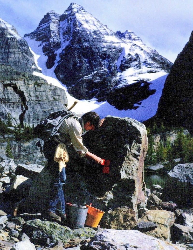 Park Warden Tim Auger painting route markers at Lake O'Hara in the early 1970s.